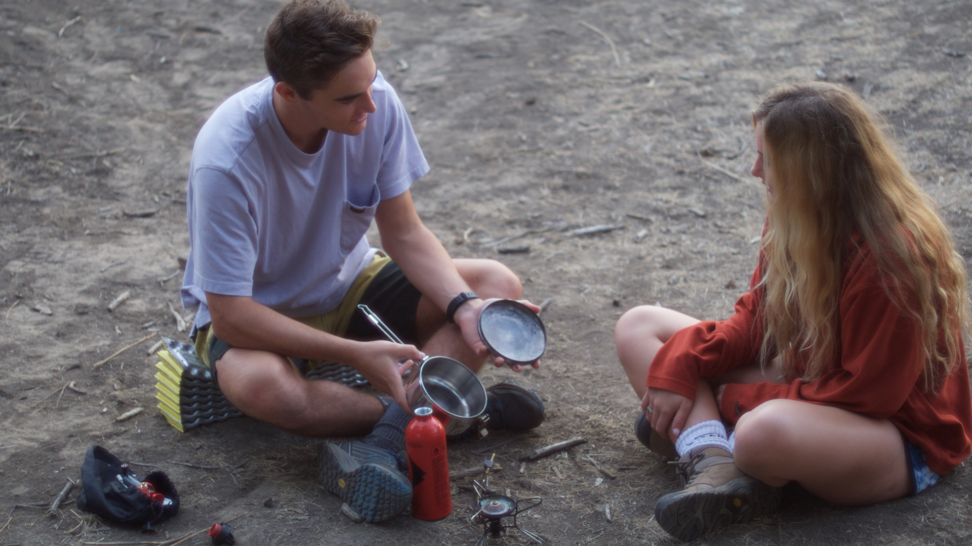 Camping and Cooking:
“Cooking with a backpacking stove is easy and fun, but only if you have everything prepared. Find a comfortable spot and have everything you need within arms reach because a hot flame and a tiny pot leave little room for error,” Patrick (left) explained to Rebecca (right). 